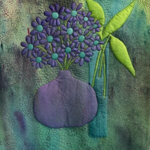 Purple flowers in a textured vase on a green background.