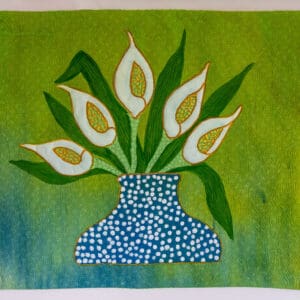 A blue vase with white flowers on a green background.